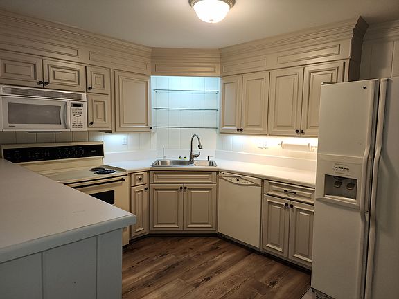 Fully equipped kitchen with more cabinets in other room