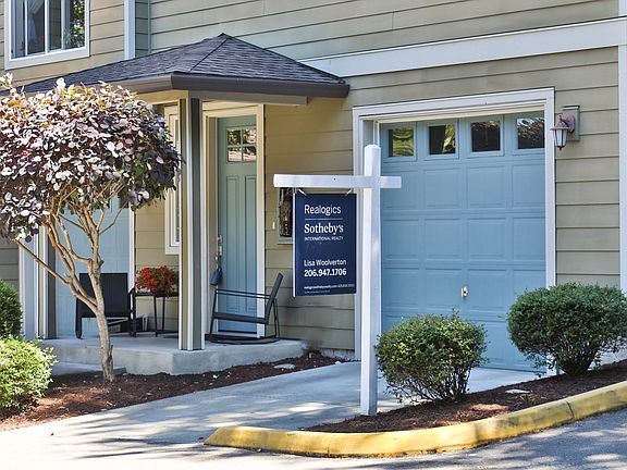 2-car tandem garage and covered front porch with space for seating.
