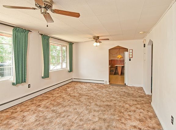 Living Room Featuring Two Ceiling Fans