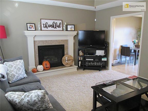 Warm and welcoming great room with gas fireplace and tray ceiling.