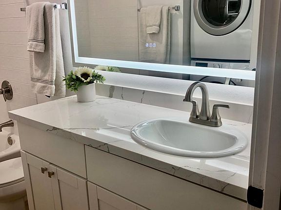 Full bath-New large LED mirror, new quartz countertops, new cabinets, new toilet, new sink and new fixtures, new luxury plank waterproof flooring, full-size washer dryer