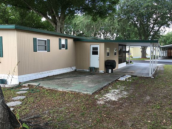 Back of Home with Attached Shed and Patio Area