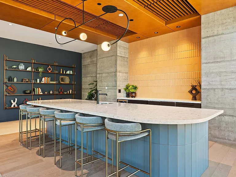Blend comfort and style in a modern lounge with a kitchen island bar, perfect for entertaining.