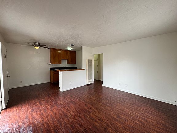 Huge living room with eating area and kitchen featuring granite countertops.
