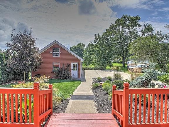 From the rear deck, note the beautifully landscaped and finished yard, sidewalk and parking.  (The driveway is an alley and is m