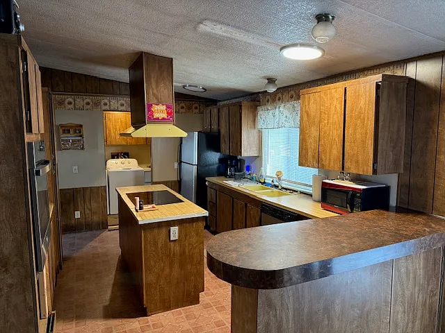 Full kitchen with plenty of storage and work space. Laundry room just off of kitchen.