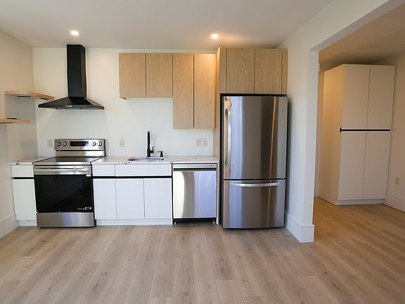 Kitchen includes, dishwasher, stove, refrigerator and microwave. Hood vents outside.