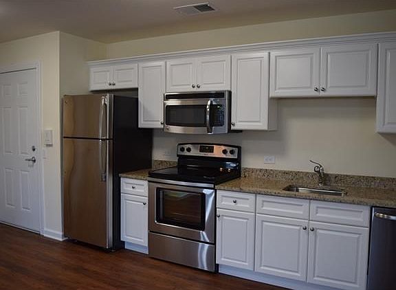 Kitchen with granite countertops, stainless steel appliances