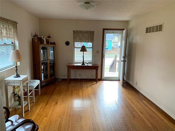 View looking from living room towards dining room. Built-in cabinets.