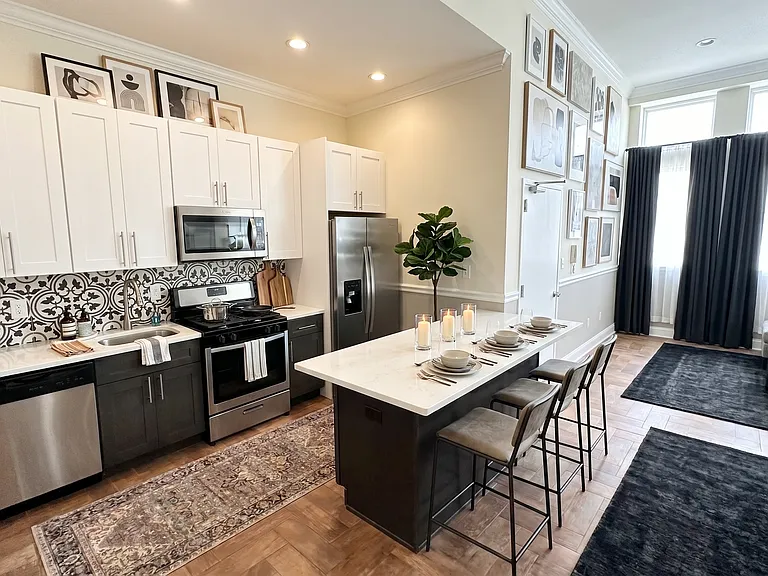 large kitchen with island that acts functionally to entertain guests while cooking and or watching tv