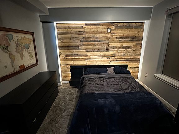 Custom wood wall in bedroom with accent lighting