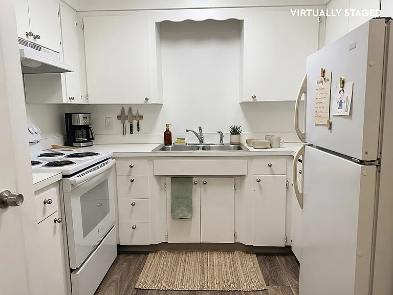 A white kitchen with plenty of storage space.