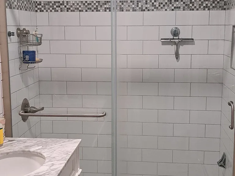 Upstairs bathroom has a floor to ceiling, tiled walk-in shower