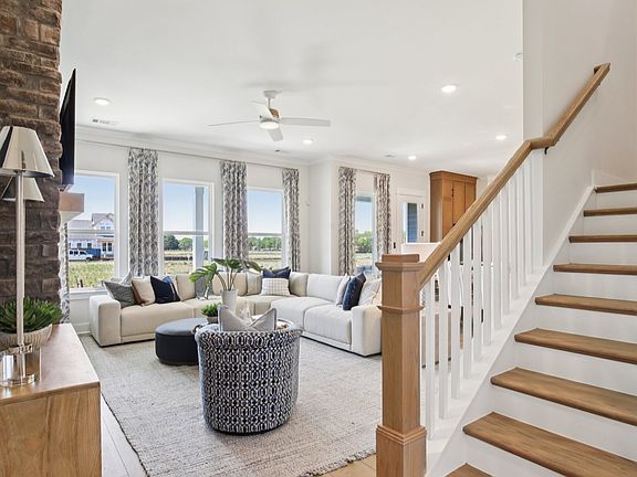 Bright and open concept first floor and staircase with oak treads and painted risers