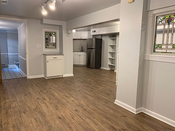 View of kitchen and entryway from living room