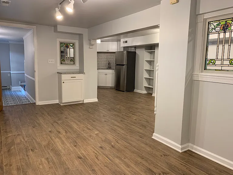 View of kitchen and entryway from living room