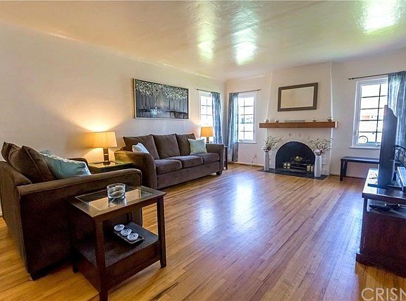 Great space with plenty of light, original hardwood floors, Fireplace Mantel made from reclaimed woo