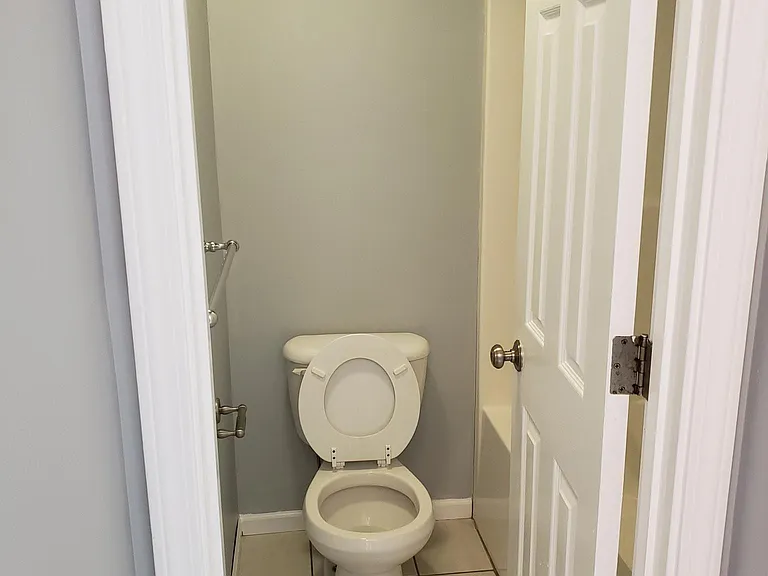 Commode w/ bath tub and shower in master ensuite
