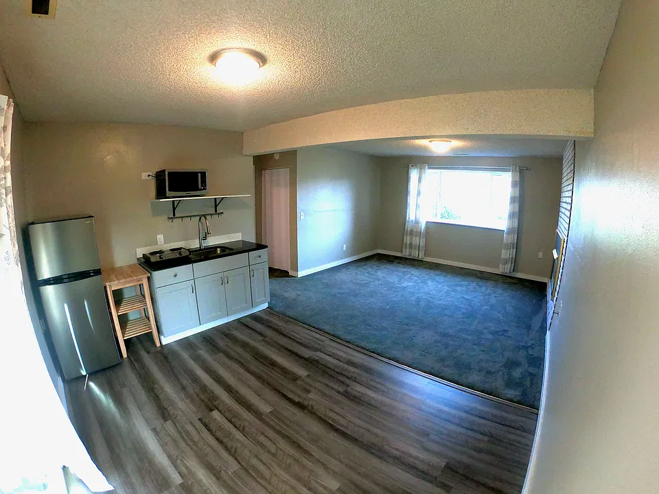 Spacious private living room with attached dining room and kitchen.
