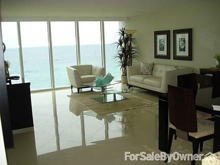 Direct ocean view upon entering : large impact glass, floor to ceiling, open living room, condo is o