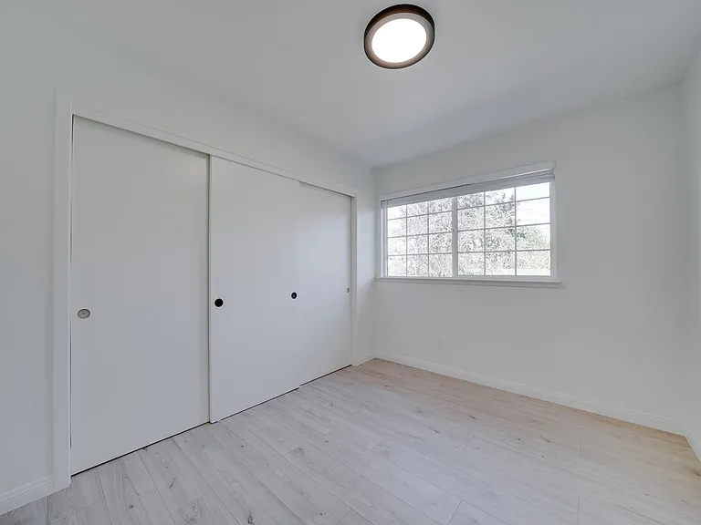 4th bedroom. New paint, blinds, flooring, light fixtures. Closet on the left, new handles will be installed.
