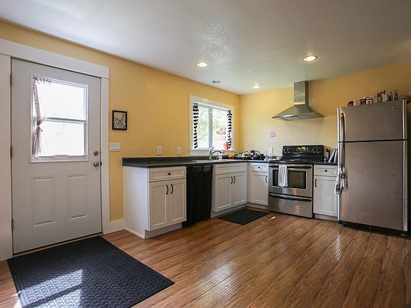 The kitchen has been repainted to a lighter color, see other kitchen images for reference. I included this image for size context.