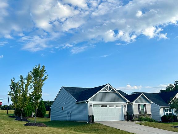 Trees around the side and back perimeter of the yard are the HOA's responsibility to maintain. The small slope in the backyard is where the trees are and that is not our property. HOA also mows the lawn beyond the trees.