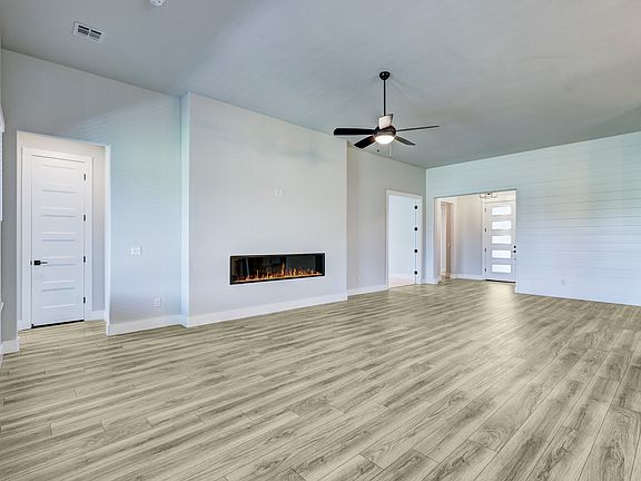 Spacious living room with a fireplace, perfect for cuddling up with a good book.