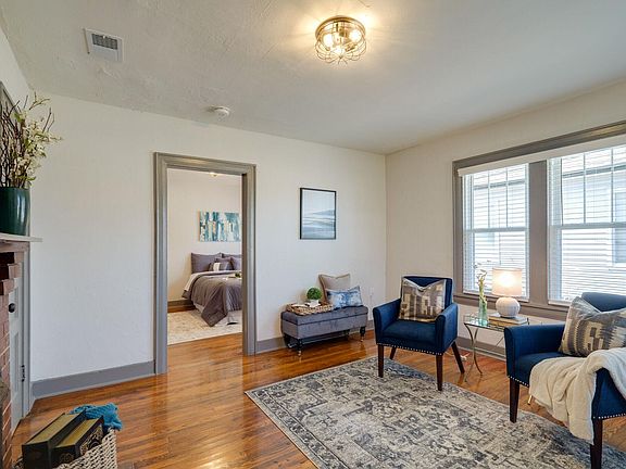 Welcome to your spacious living room with new paint, new windows, new blinds, and new light fixture!