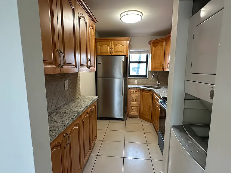 Kitchen with new range and in unit washer dryer combo