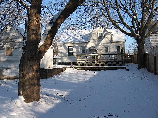 back of the house with a full deck