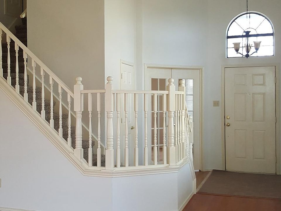 Entrance with Master upstairs. French doors at the foot of
