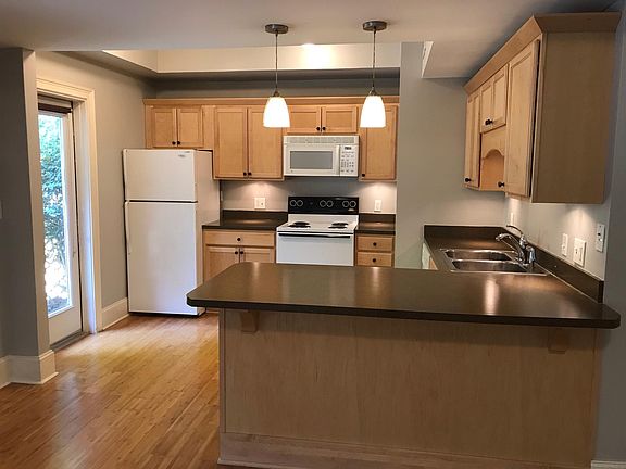 Kitchen features a dishwasher, disposal, electric stove, refrigerator, and built-in microwave.