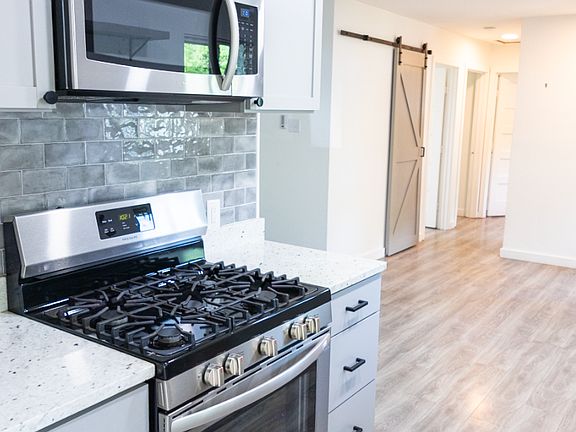 upgraded appliances and beautiful tile backsplash
