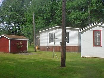 Back view of the home and 2 sheds.