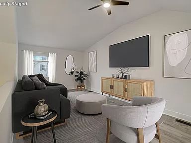 loft overlooking stairs 
with cathedral ceiling, ceiling fan, closet and window (3rd bedroom?)