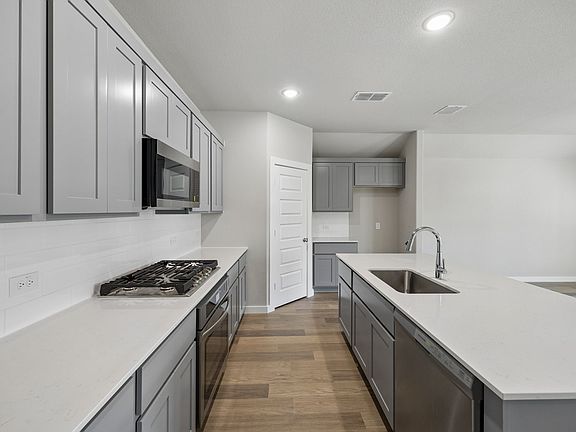Kitchen in the Emmy II home plan by Trophy Signature Homes - REPRESENTATIVE PHOTO