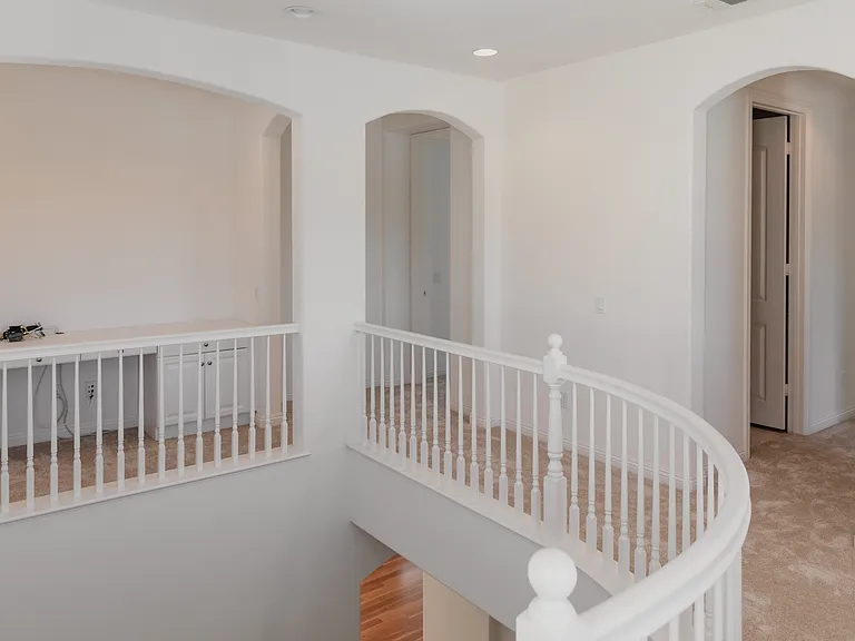 from top of stairs you can see the hallway to bedrooms, laundry room, and office nook