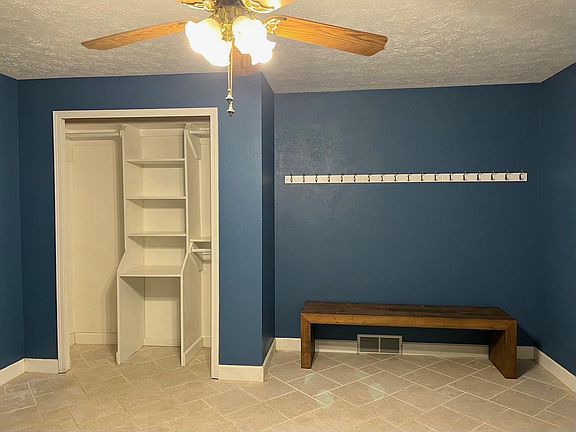Spacious mudroom with bench and coat hangers