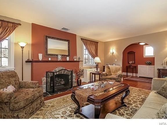 Stone Fireplace, Arched Entry, Wood Floors ,Lovely Sconces
