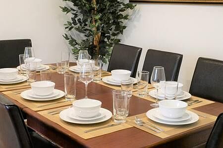 The dining room table can comfortably accommodate 8 people.