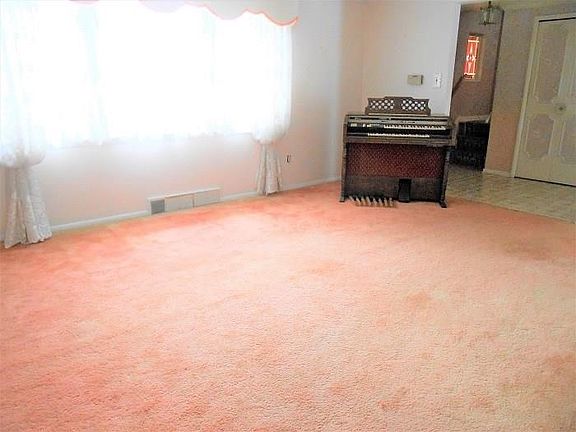 Another view of the spacious Living Room (as seen from doorway which leads to the  Dining Room).  Window treatments in this room
