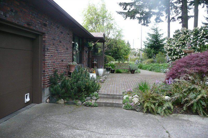 Immaculate Brick Rambler poised on a shy quarter acre with patios, gardens, privacy.