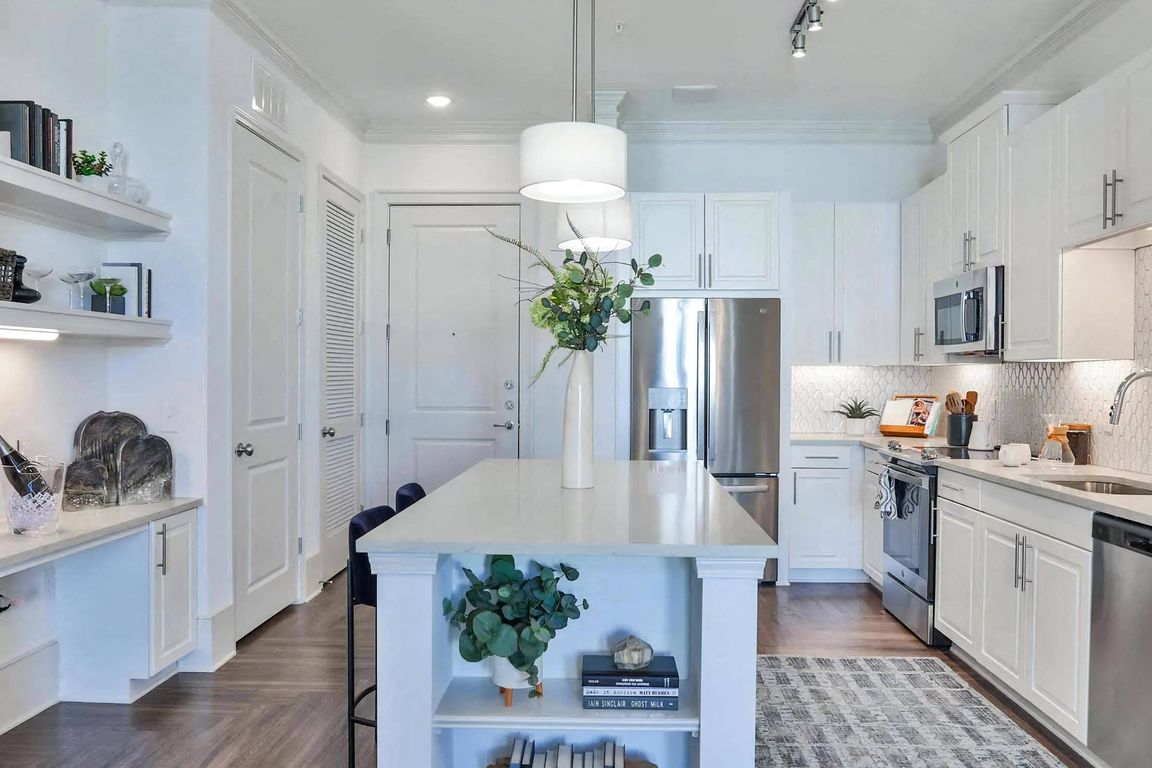 Apartment Kitchen with Island Storage, Shelves, and Stainless Steel Appliances