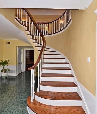 Large entry foyer with elegant flying staircase.