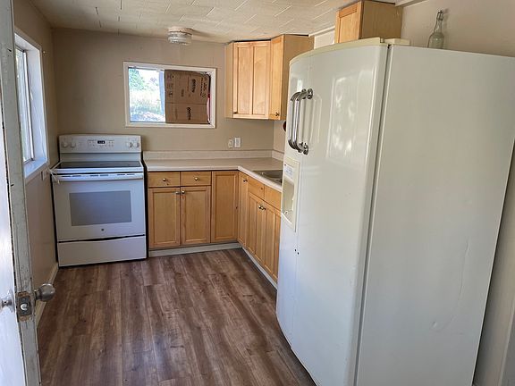 Bright kitchen with outside door access and adjacent dining area.