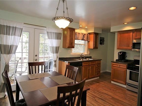 Open dining/kitchen space with double doors leading to deck