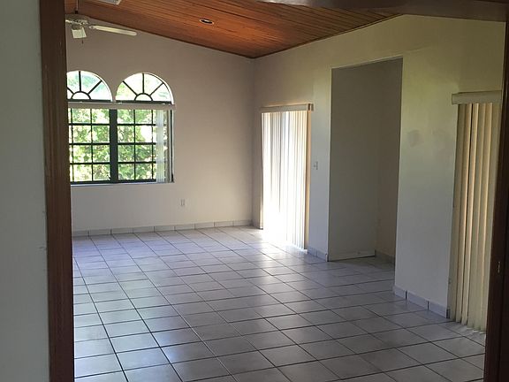 Oversized family room with double doors leading to terrace and patio.
