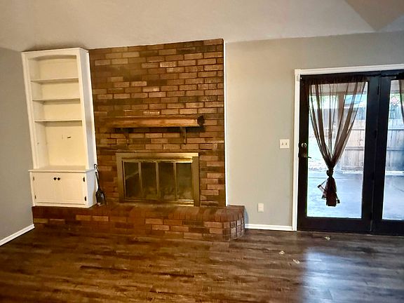 Fireplace with french door leading to covered patio