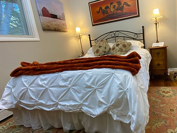 Bedroom 1, Model has a queen sized bed.